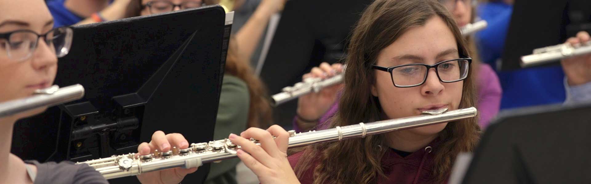 Student Playing Flute in Band Class